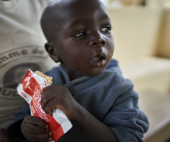 A young boy eats Plumpy'Nut, the peanut paste used to treat malnutrition.