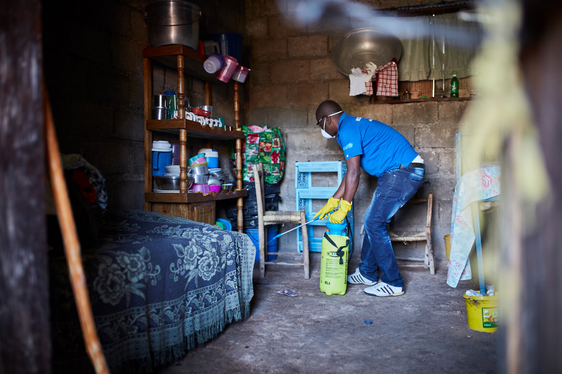 An Action Against Hunger team member disinfects a home after a suspected case of cholera was reported.