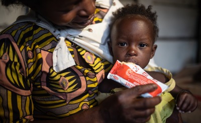 A mother feeds her child Plumpy'Nut, the peanut paste used to treat malnutrition.