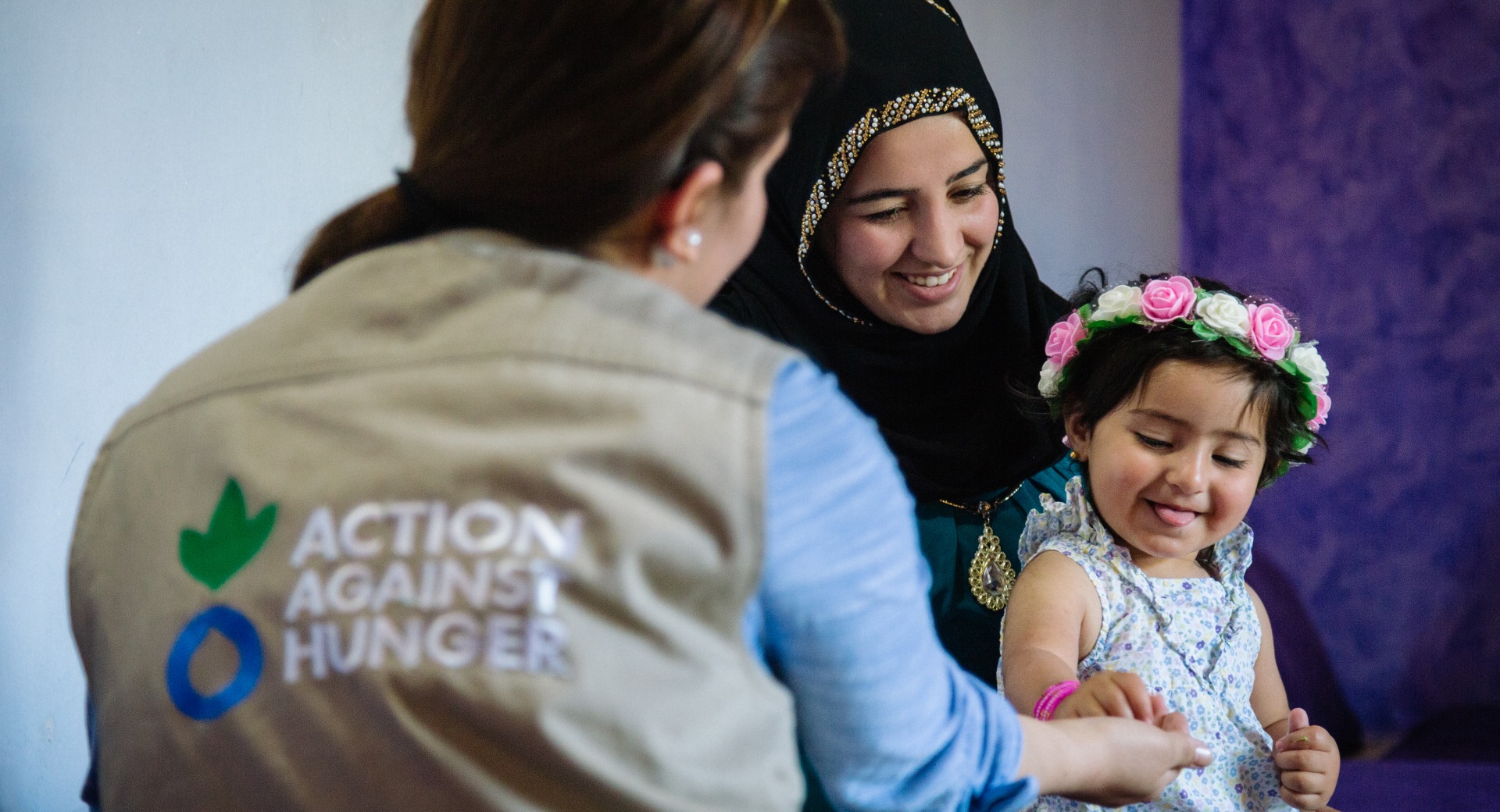 A mother and child talk with an Action Against Hunger psychosocial worker.