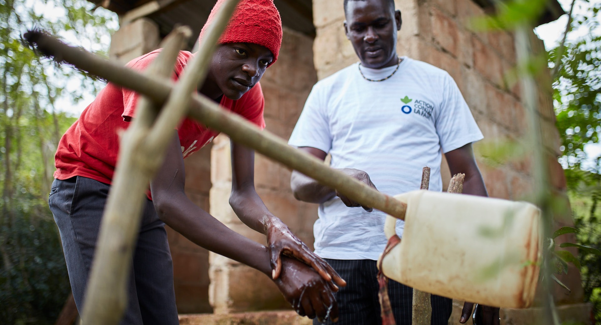 Action Against Hunger teams carry out sensitization activities with families to teach about good hygiene and encourage use of latrines.