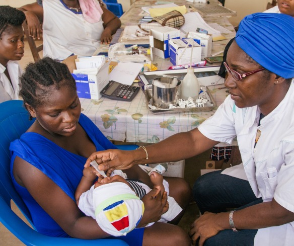 Health workers provide care to a mother and child in Ivory Coast.