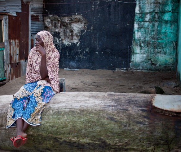 A woman sits in the West Point slum in Monrovia.