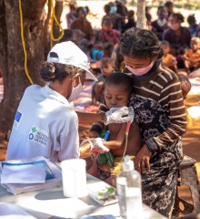 An Action Against Hunger aid worker measures a child for malnutrition.