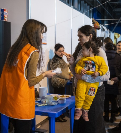 A woman asks for help at a shelter for Ukrainian refugees.