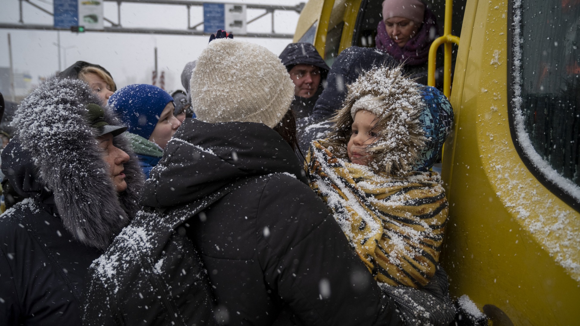 Ukrainian refugees face winter weather as they board a bus and cross the border into Moldova.