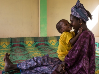 Mother and child together at an Action Against Hunger nutrition center.