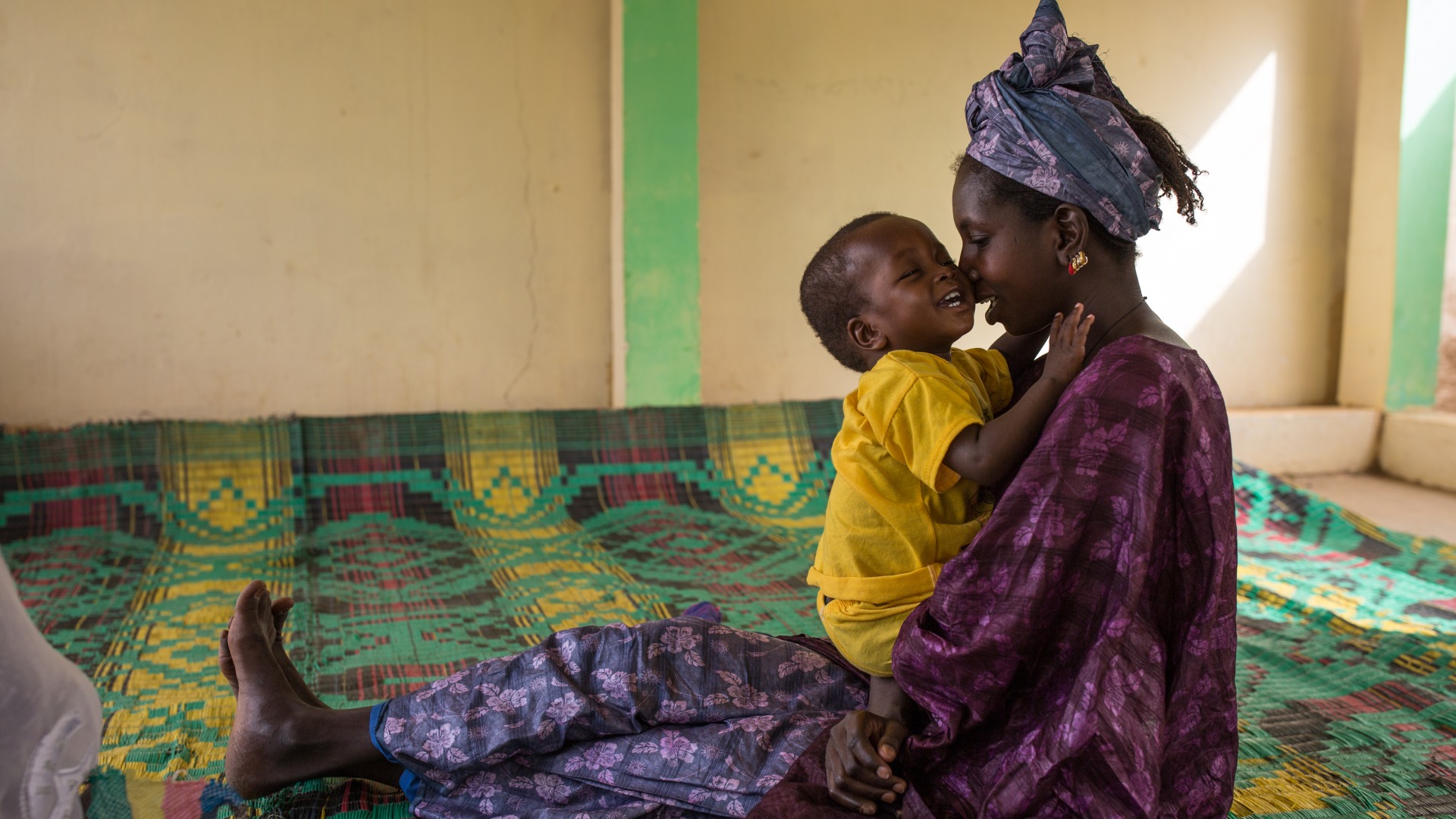 Mother and child together at an Action Against Hunger nutrition center.