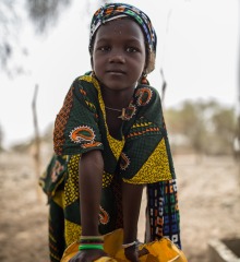 A young girl with a jerrycan.