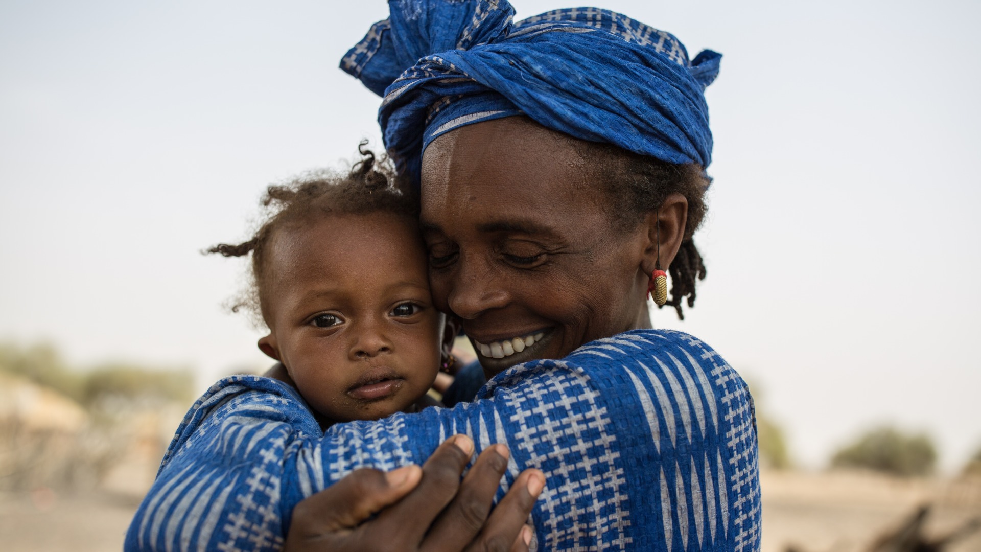 A woman hugs her daughter