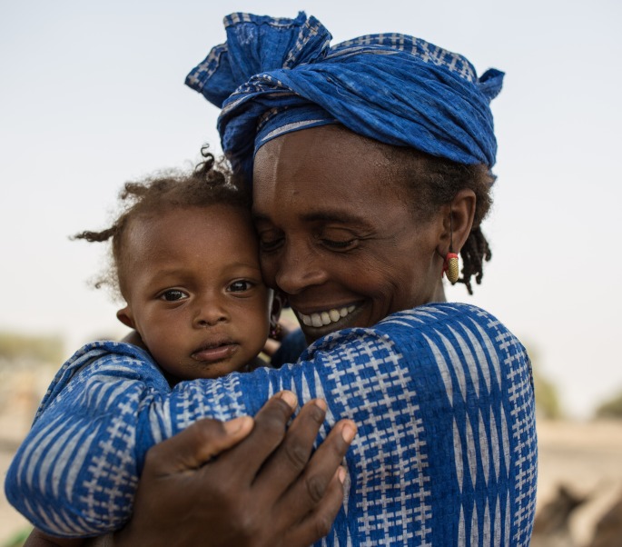 A woman hugs her daughter