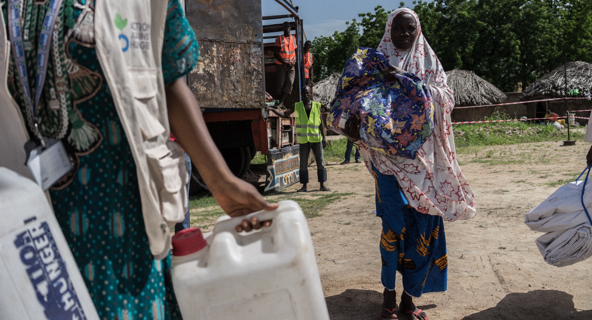 Action Against Hunger staff conduct a distribution of hundreds of shelter kits and hygiene kits to displaced people in Monguno, Borno State, Nigeria