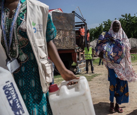 Action Against Hunger staff conduct a distribution of hundreds of shelter kits and hygiene kits to displaced people in Monguno, Borno State, Nigeria