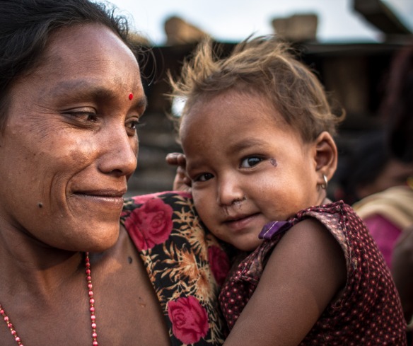 A mother holds her daughter in Nepal.