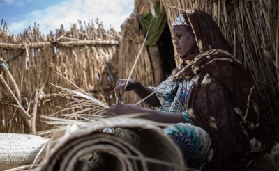 A woman weaves baskets in Niger.