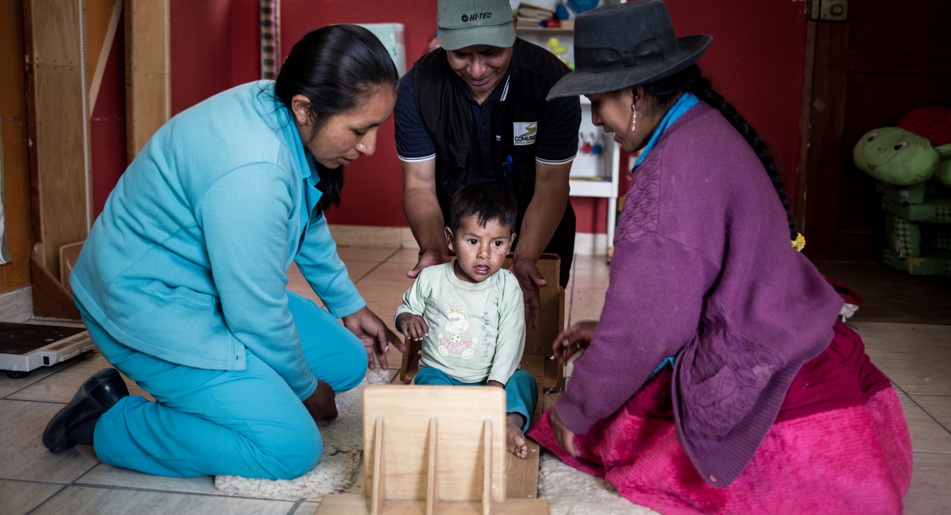 Action Against Hunger staff measure a child's height to determine his nutrition status.