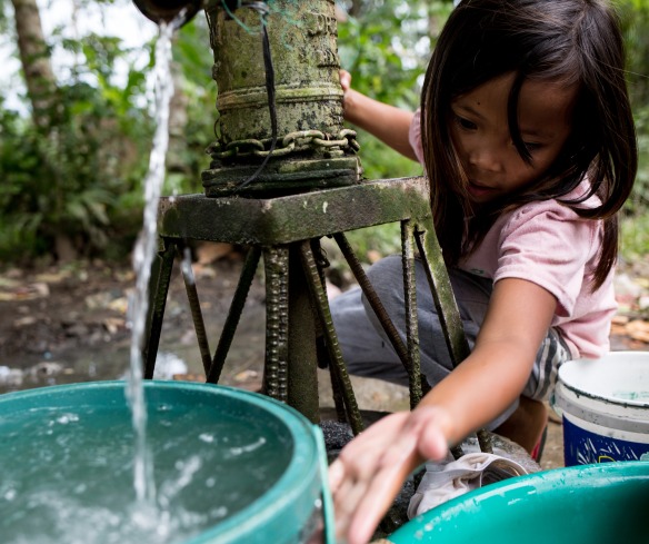 A girl collects clean water.