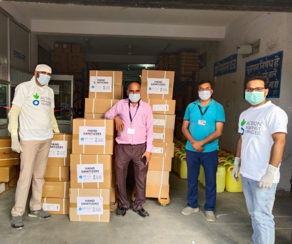 Action Against Hunger staff get supplies of hand sanitizer, masks, and gloves ready for distribution in Rajasthan, India.