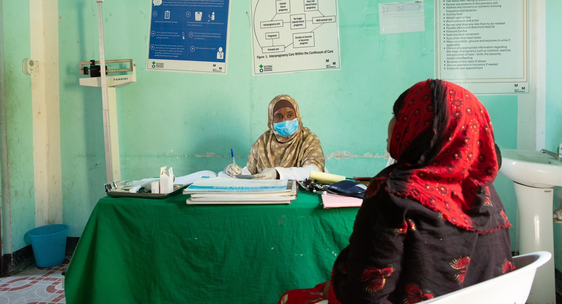 A mother consults with a nurse at one of Action Against Hunger’s Health & Nutrition Centers in Somalia.