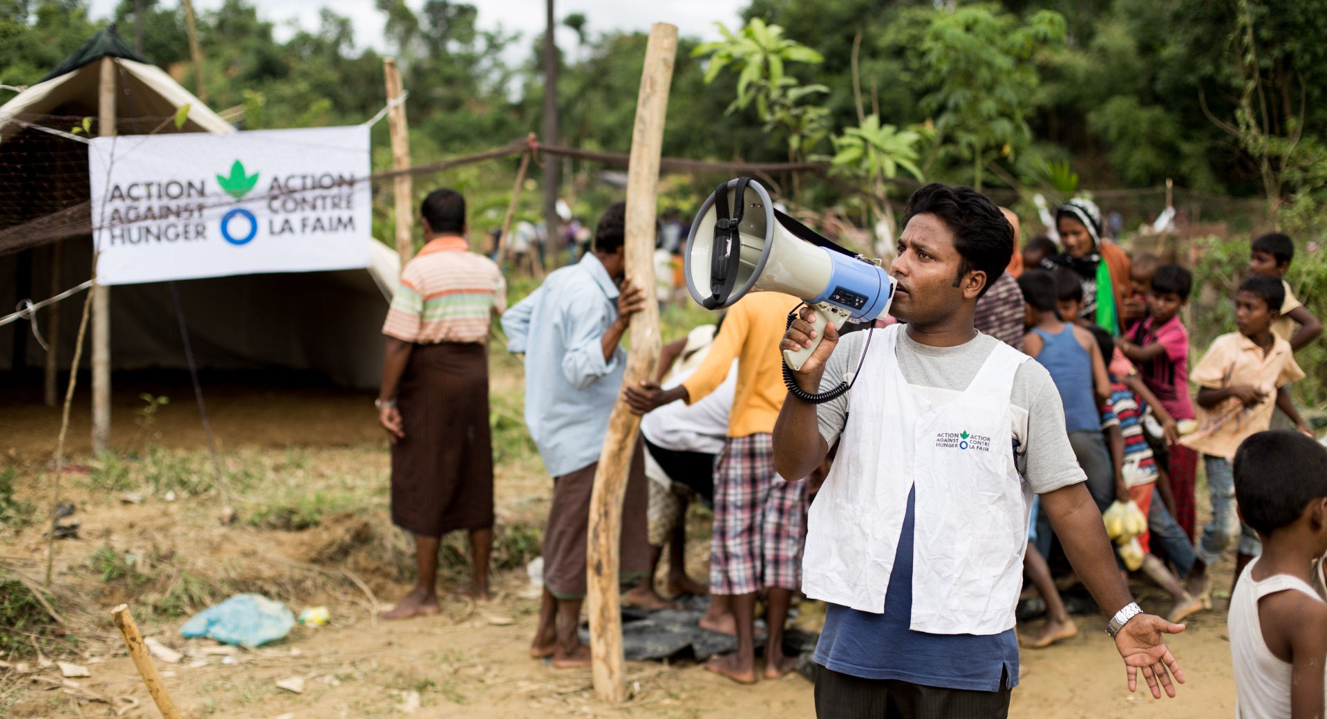 An Action Against Hunger aid worker organizes an emergency food distribution for Rohingya refugees in Cox's Bazar, Bangladesh