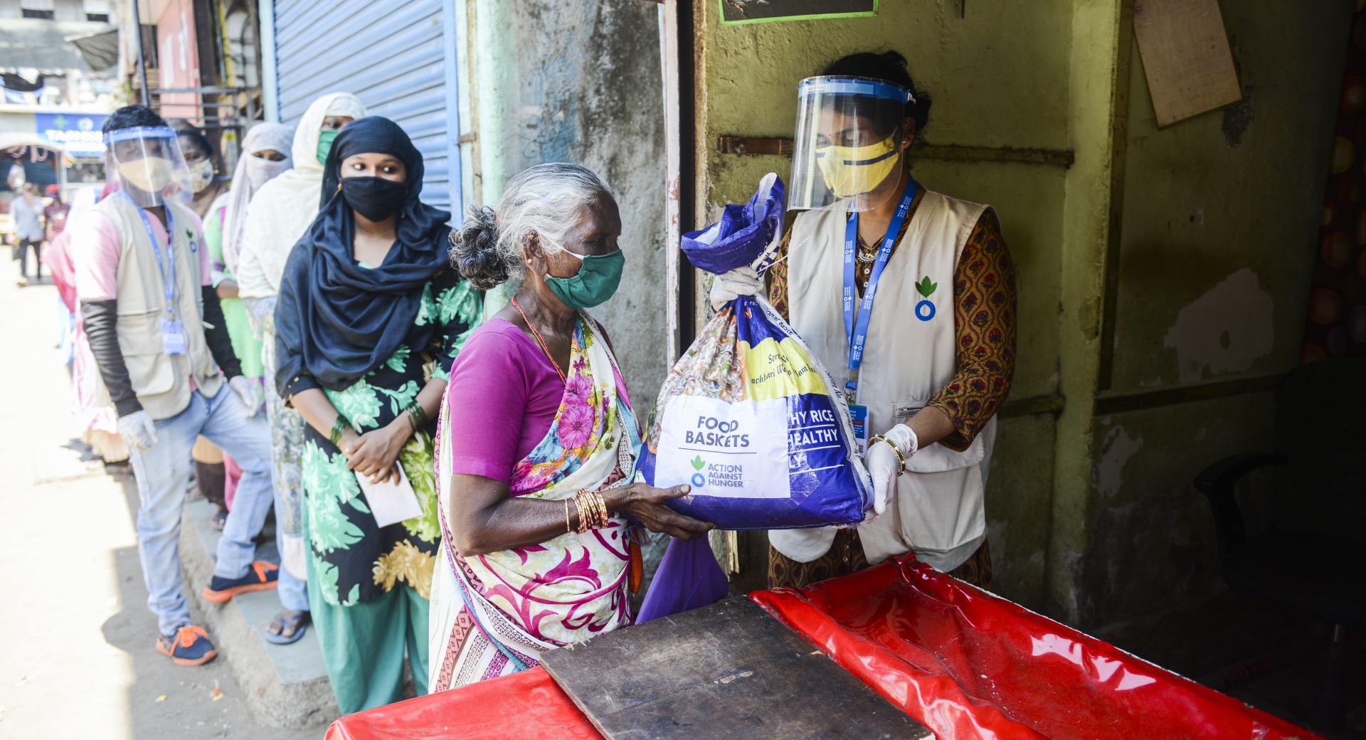 One of Action Against Hunger's Community Mobilizers distributing food baskets in Mumbai.