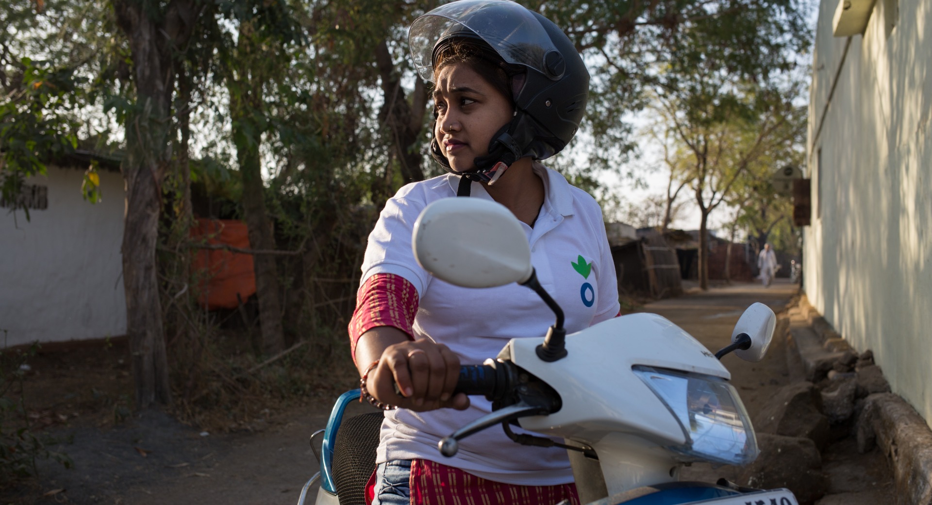 Community Mobilizer Kavita uses her motorbike to go home to home in her community.