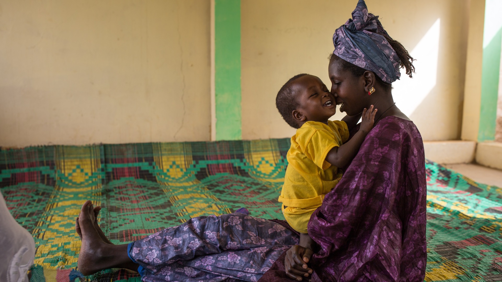 Mother and child together at an Action Against Hunger nutrition center.