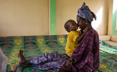 Mother and child together at an Action Against Hunger nutrition center.