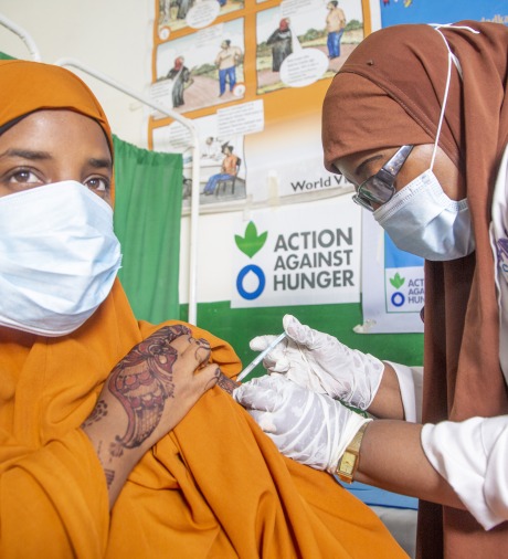 A nurse at Waberi Health Centre administering the second dose of COVID-19 vaccina jab to a young lady.