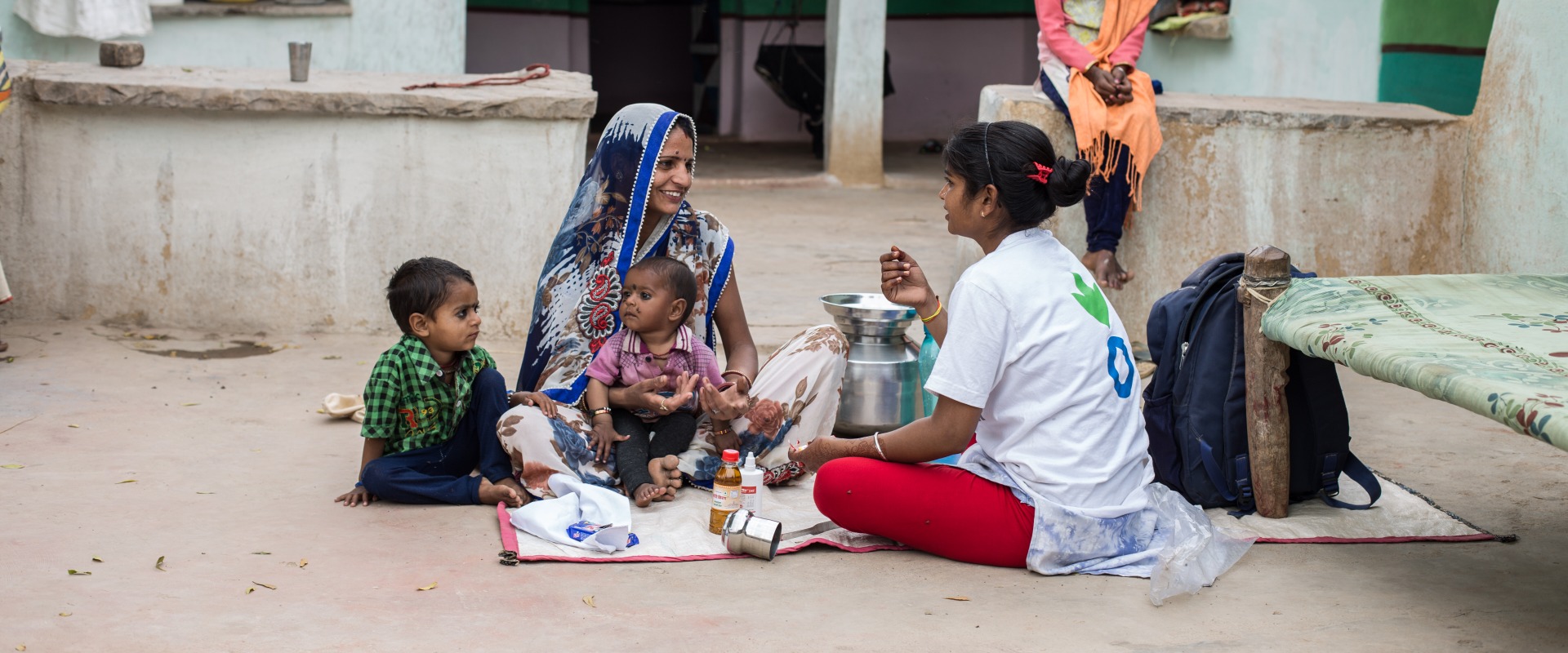 An Action Against Hunger Community Mobilizer visits with a family at their home.